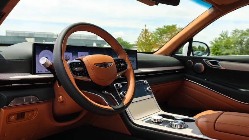 The 2026 Genesis GV80 luxury midsize SUV showcasing an athletic design, distinctive crest grille, and three-row seating.